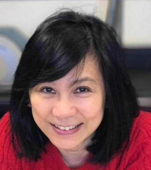 Close of up Asian writer of article, she's wearing a red sweater and has medium length hair.