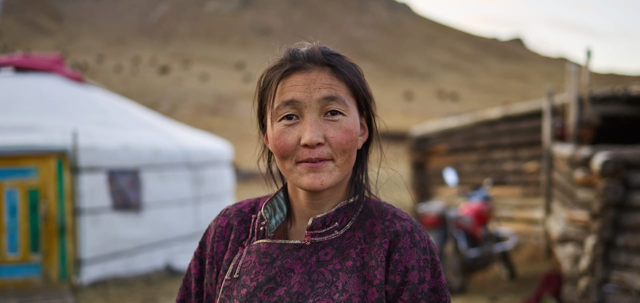 Mongolian woman in front of yurt
